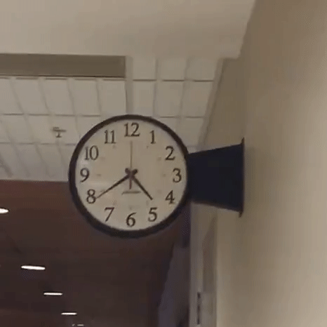 Animated GIF of a fast moving hands on a clock.